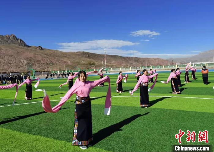 圖為青海師范大學(xué)附屬玉樹實(shí)驗(yàn)學(xué)校學(xué)生在綠茵場跳起囊謙古舞—卓根瑪。　白劼 攝